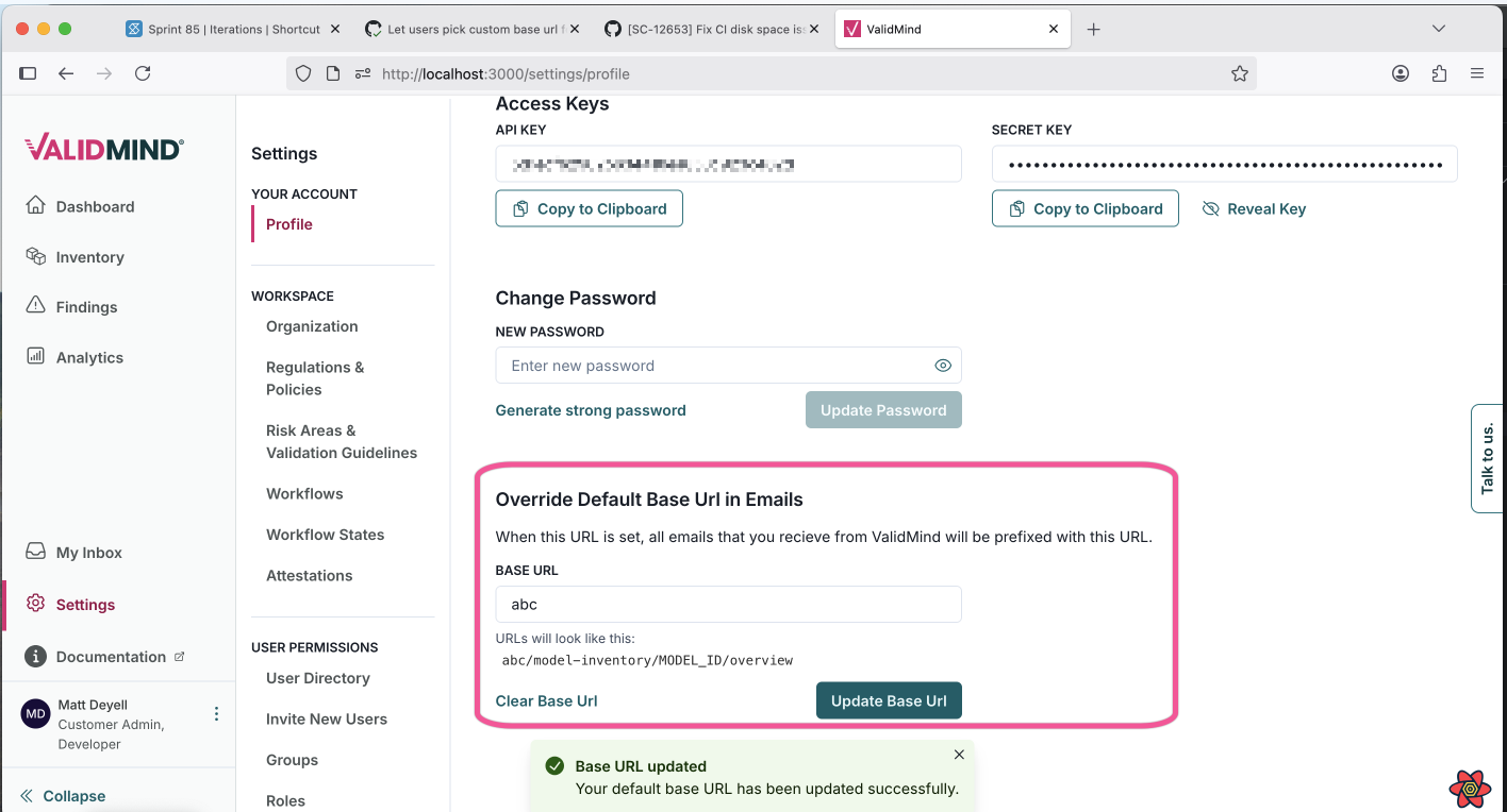 A web interface for managing user account settings is displayed, with a sidebar on the left featuring menu items such as Account, Profile, and Notifications. The main section shows a panel titled Access Keys with a text field containing a key and a button labeled Copy to Clipboard. Below, there is a Change Password section with fields for entering a new password and buttons for generating a strong password and updating the password. Further down, the Override Default Base URL in Emails section includes a text field for the base URL and buttons labeled Clear Base URL and Update Base URL. A green notification at the bottom confirms that the base URL has been updated successfully.